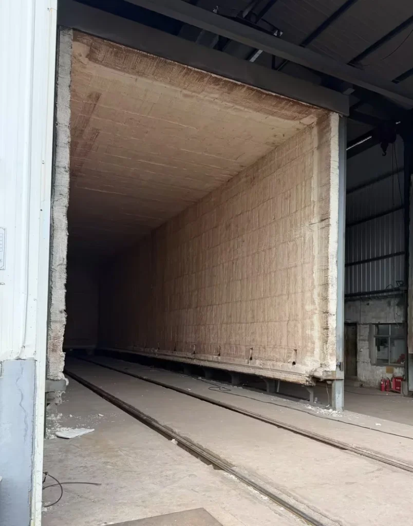 Massive 25m x 5.5m industrial heat treatment furnace at DHB Boiler for processing large T91 boiler superheater coils.